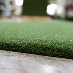 Close-up of artificial grass with a blurred indoor background