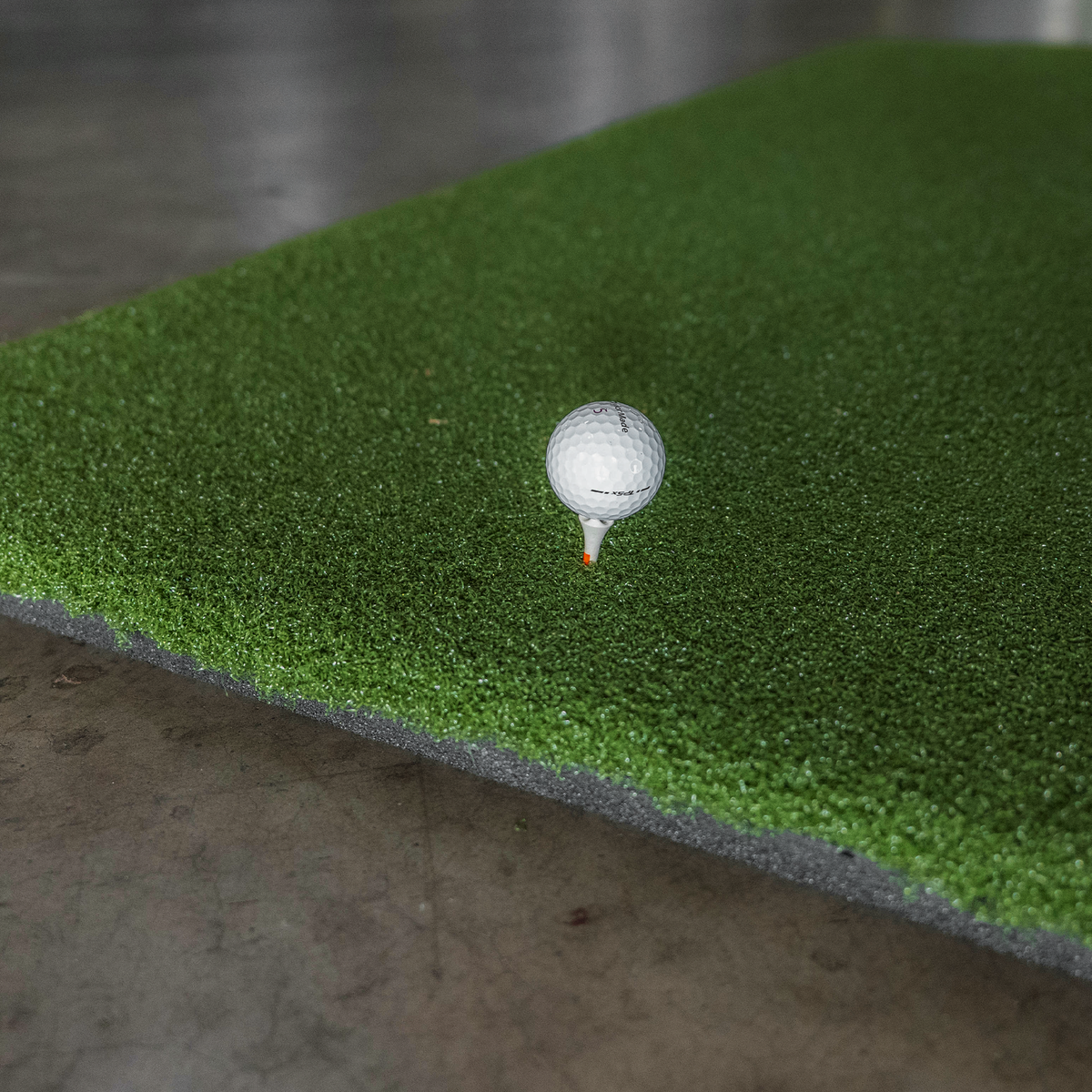 Super Tee golf mat holds real wooden tees at any height